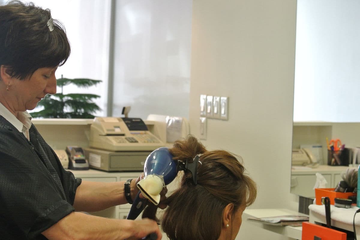 Hair salon woman brushing hair and cutting hair in salon