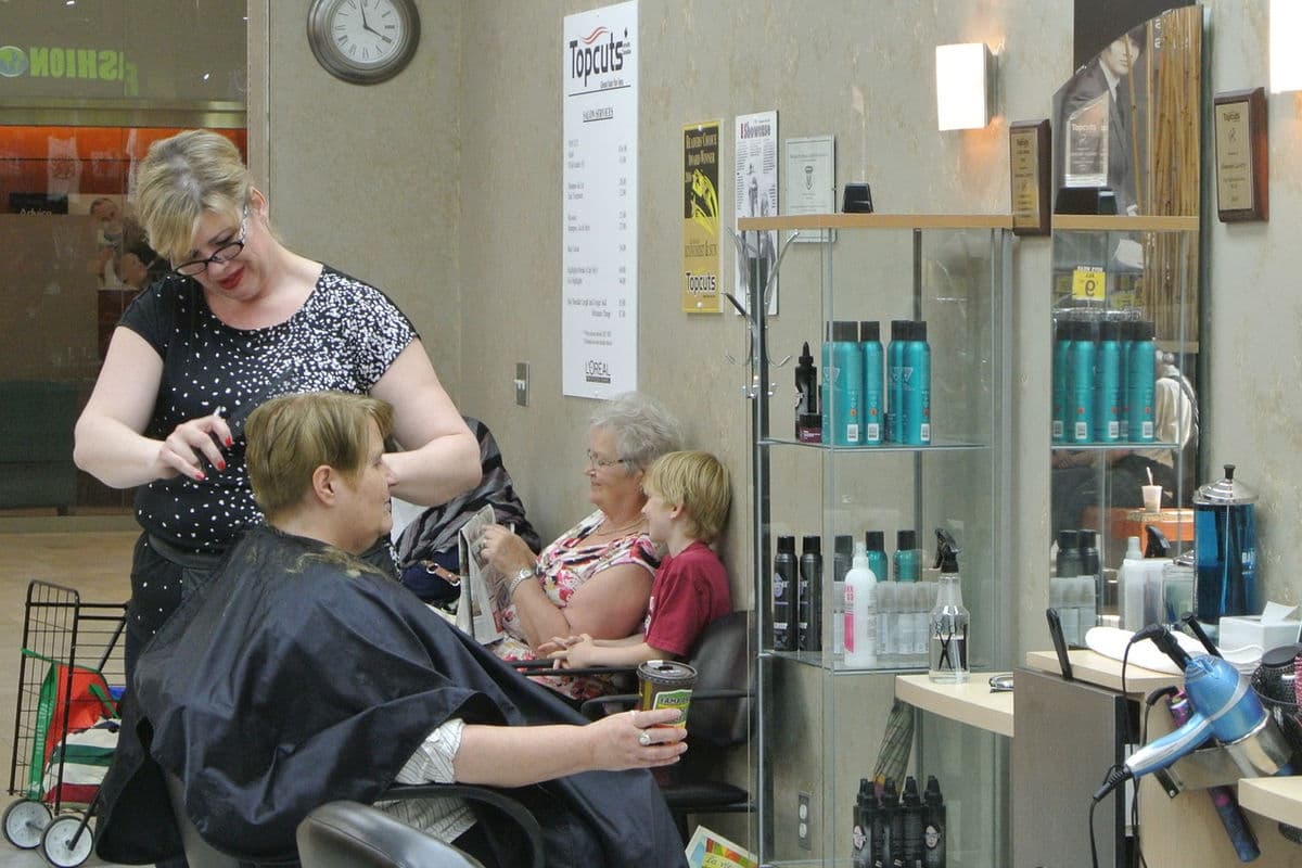 Hair salon stylist cutting hair
