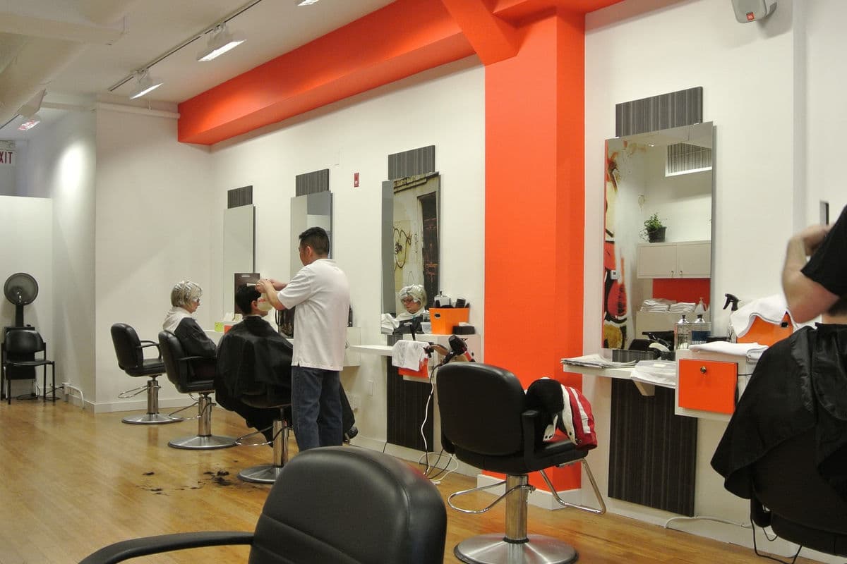 Hair salon with clients receiving haircuts