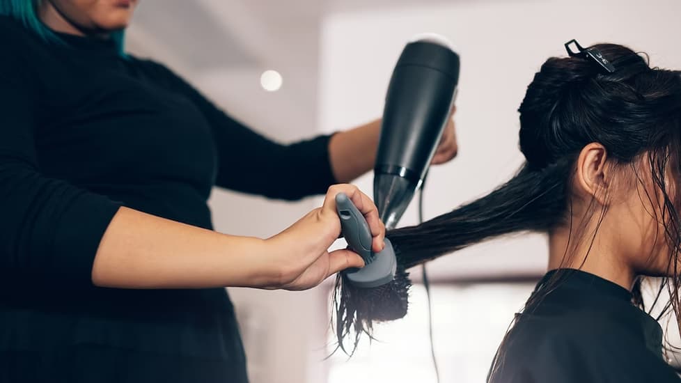 A stylist at work inside a Topcuts salon