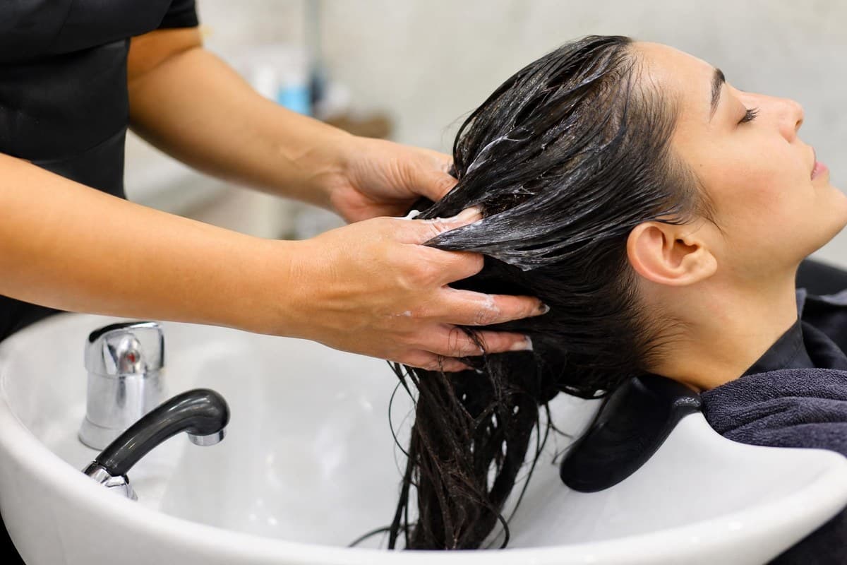 Hair treatment being applied at a Topcuts shampoo station.
