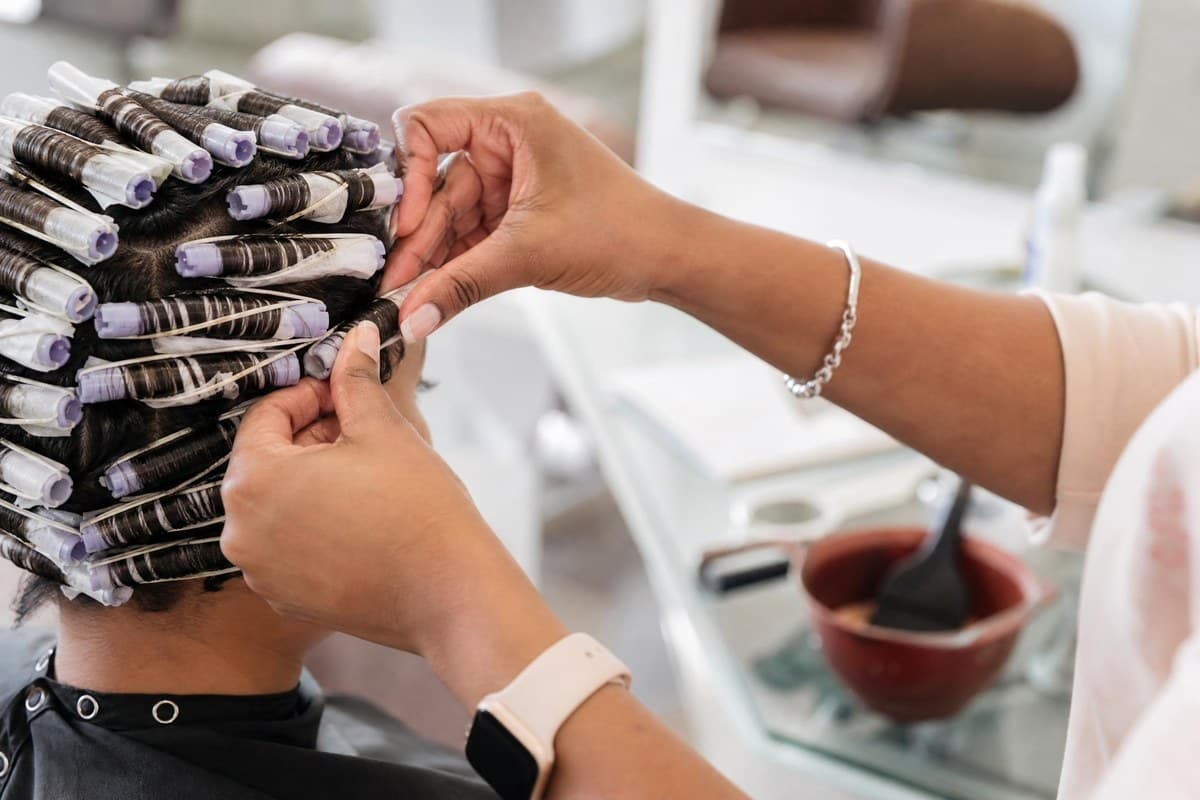 Perm rods being placed during a Topcuts salon service.